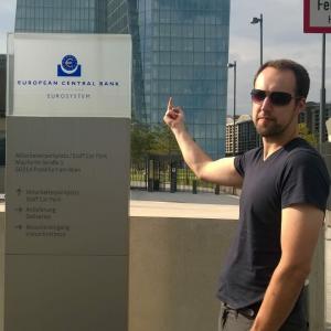Tobias points his middle finger at a sign of the European Central Bank